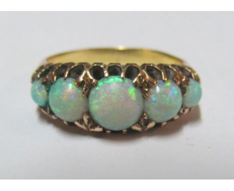 A gold coloured five stone opal ring, size L