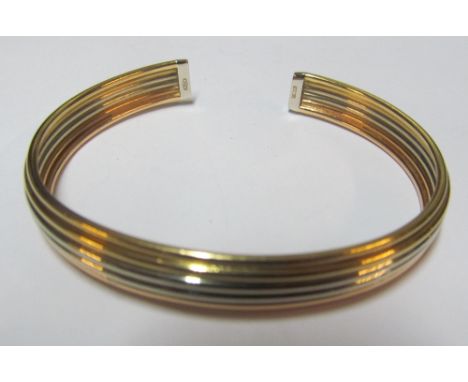 A yellow metal two colour bangle bracelet 17.1g