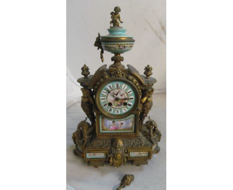 A 19th Century porcelain and gilt mantel clock with finial