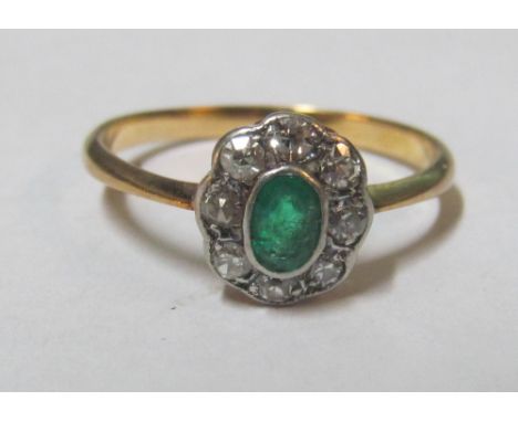 An emerald and diamond ring size M