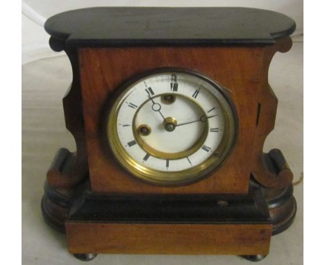 A mahogany and ebonized mantel clock