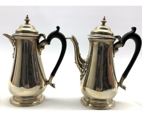 Pair of silver cafe au lait pots with domed covers and urn finials with ebonised handles H19cm Sheffield 1913 Maker Harrison 