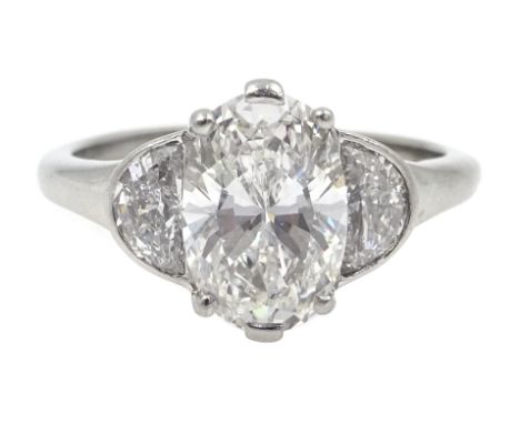 Platinum three stone diamond ring, the oval centre stone of approx 1.80 carat with two half moon cut diamonds either side, ea