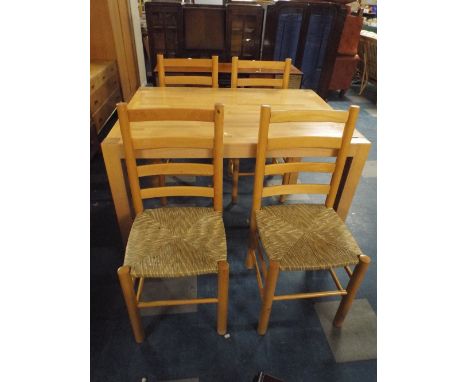 A Rectangular Extending Modern Kitchen Table and Four Rush Seated Ladder Back Chairs. 