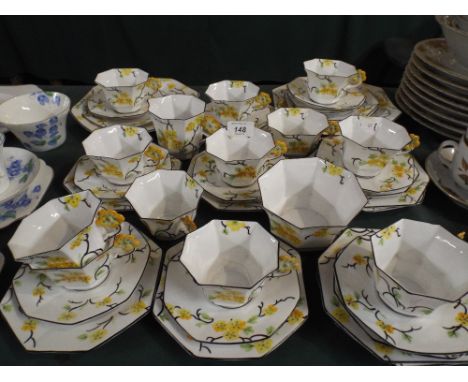 A Melba Bone China Art Deco Tea Set Comprising Twelve Cups Saucers and Side Plates Sugar Bowl and Cream Jug. 