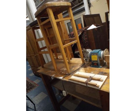 A Wooden Work Bench with Black and Decker Grinder and Two Stools. 