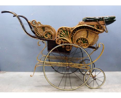 Vintage wood and wrought metal framed perambulator with green leather upholstery and wicker decoration on steel sprung and sp