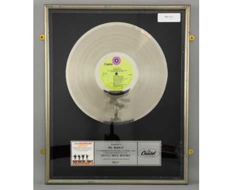 The Beatles - Platinum Disc Presented to The Beatles to commemorate the sale of more than 1,000,000 copies of the CAPITOL / A