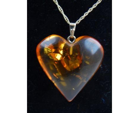 10ct yellow gold amber heart pendant, suspended on a 9ct yellow gold chain. 