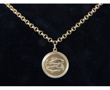 A 9ct yellow gold pisces pendant, on a yellow metal chain, total weight 13.5g.