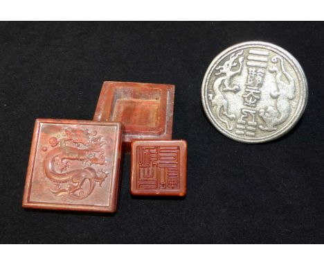 Chinese soapstone seal, held in a hardstone case, the cover decorated with a dragon, plus a Chinese white metal seal stamp. (