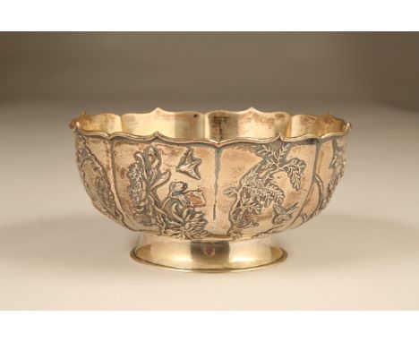 Chinese silver bowl, circular footed form, lobed rim and bowl decorated in floral and bird relief, marked Wau Kuang. 20.5cm d