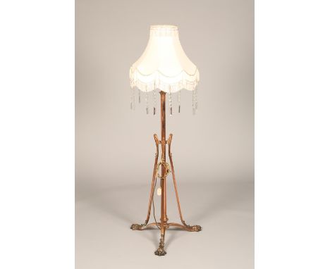 Art Nouveau copper rise and fall standard lamp modified for electric, raised on three heavy paw feet