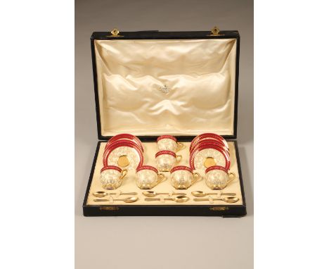 Cased Royal Worcester coffee set, 6 coffee cups with gilt interiors, 6 saucers, 6 silver gilt spoons (London 1934) The coffee