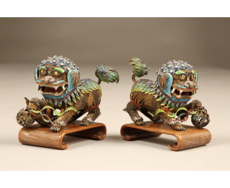 Pair of 20th Century Chinese cloisonné and silver dogs of fo, stamped silver. 9.5cm long 6.5cm high The pair of dogs are in e