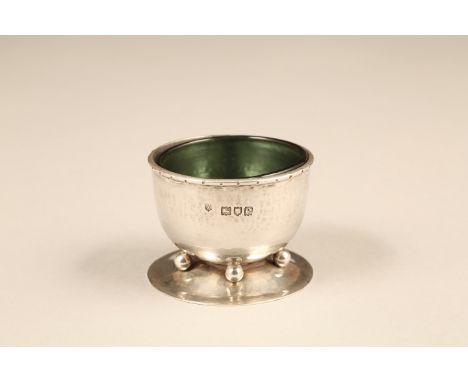 Arts & Crafts silver hammered table salt with original green glass liner. Assay marked London 1900. By Charles Robert Ashbee,