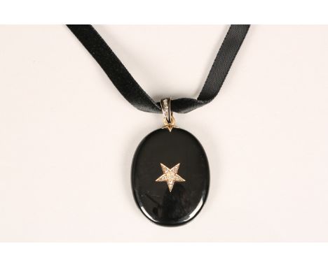 Victorian enamel and diamond mourning pendant. Oval black enamel pendant set to centre with 11 old cut diamonds in a star for