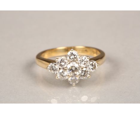 18 carat gold diamond cluster ring. Central 0.2 carat diamond surrounded by eight 0.08carat brilliant cut diamonds. Ring size