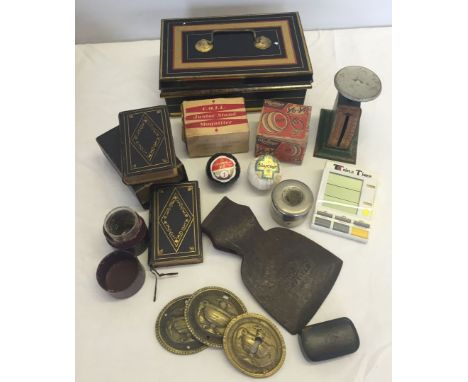 A box of miscellaneous items to include; a vintage tin, letter scales, 2 vintage wrapped golf balls and cased bibles