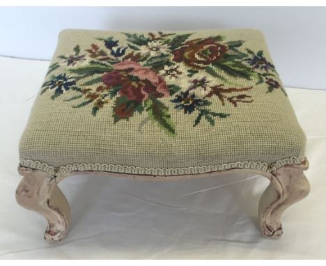 A vintage footstool with tapestry top and shabby chic paintwork