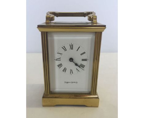 A Mapin & Webb carriage clock with bevelled egde glass and key. Approx 11cm excluding the handle.
