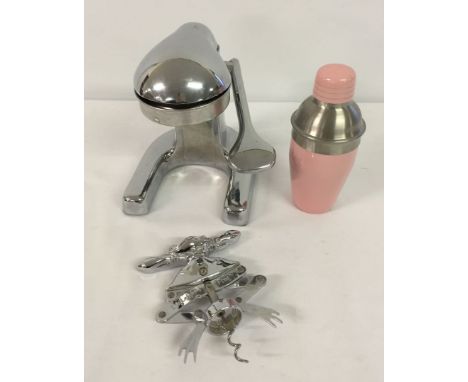 A collection of kitchen items to include a lemon squeezer, a leaping frog corkscrew and cocktail shaker.