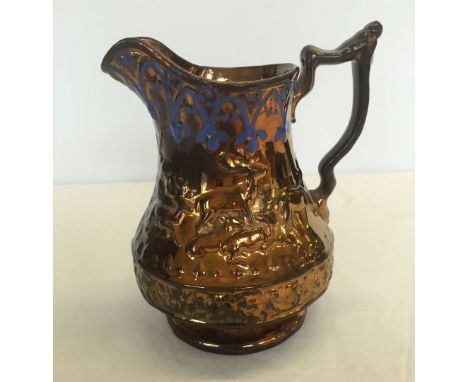 A Victorian brown lustre jug by ceramic Cork & Edge in stag pattern with blue painted design to rim. Hairline to base. Approx