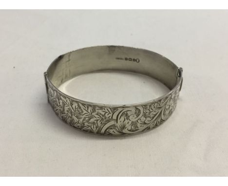 A hallmarked silver bangle, with engraved detail.  Birmingham 1935. Approx 28.2g