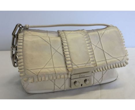 A Christian Dior cream leather handbag with heavyweight chrome links to handle. Measures approx 28cm x 17cm. Requires a clean