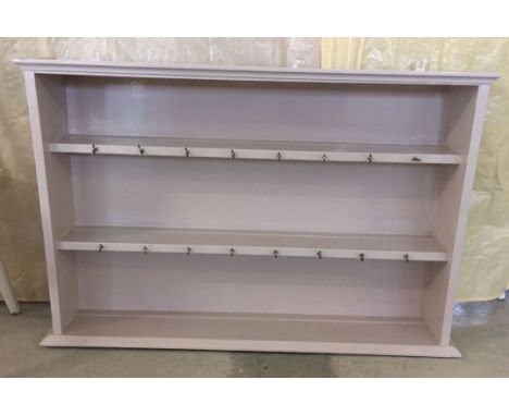 A painted wall hanging shelf/plate rack