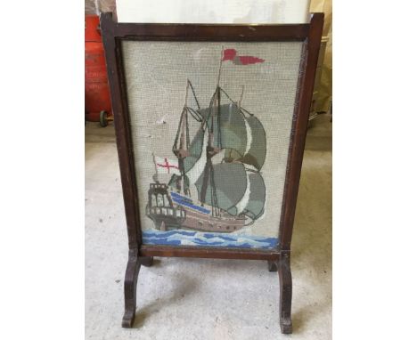 A glazed dark oak tapestry firescreen depicting a galleon.