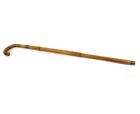 An Edwardian Bamboo Sword Stick by Swaine &amp; Adeney Ltd., London, the 70cm double edge steel blade etched with scrolling f