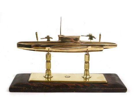 A Brass Desk-Top Model of a Second World War Submarine, with detachable parts on a wood plinth base, 26cm