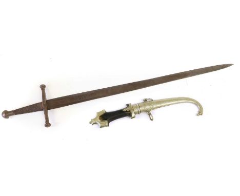 A Moroccan Jambiya, with 23cm curved steel blade, with waisted wood grip, white metal mounts and scabbard, 40cm; an Early 20t