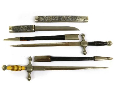 Two 20th Century Continental Police Daggers, each with 30cm double edge spear point steel blade, white metal crossguard with 