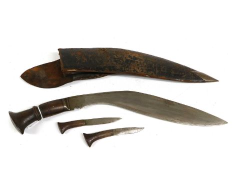 An Early 20th Century Nepalese Kukri, the 33cm curved steel blade with narrow fuller to the back edge, steel bolster, ringed 