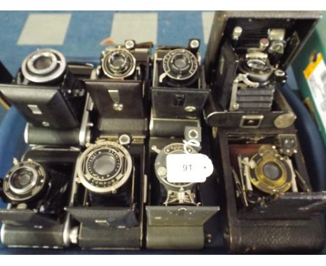 A Tray Containing Nine Vintage Folding Cameras 