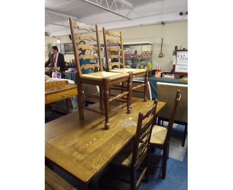 An Oak Refectory Style Dining Table and Four Ladder Back Chairs 