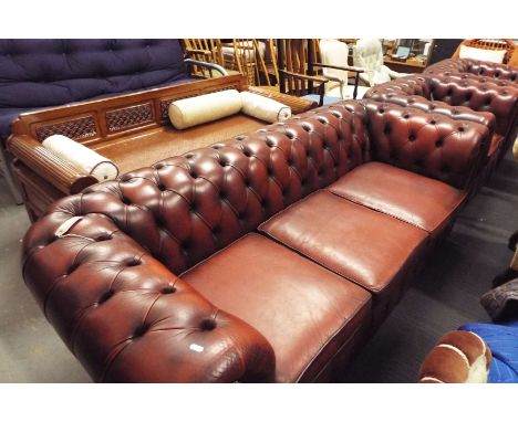 A red leather button back studded Chesterfield three seater settee