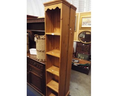 A narrow pine five shelf bookcase