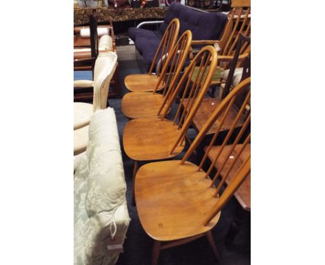 Four Ercol hoop and spindle back dining chairs