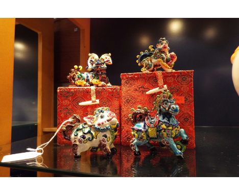 Four oriental ceramic animals in boxes, one A/F