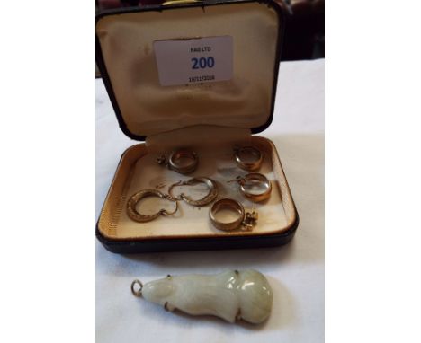 Three pairs of gold earrings and a jade pendant