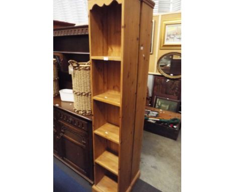 A narrow pine five shelf bookcase