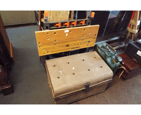A Black & Decker workmate, a tin shipping trunk, a metal jerry can, brass fender and a wooden step ladder