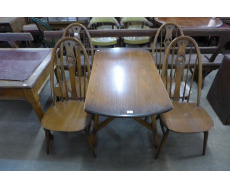 An Ercol Golden Dawn elm and beech six piece dining suite, comprising drop leaf table, four swan back chairs and a dresser 
