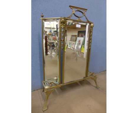 An Art Nouveau brass firescreen 
