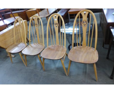A set of four Ercol Blonde elm and beech swan back chairs 