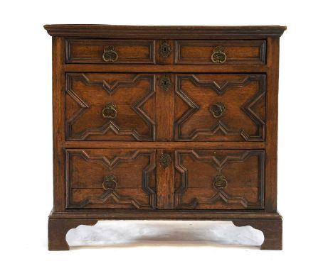 A Late 17th Century Joined Oak Geometric-Moulded Chest, the moulded top above three two-as-one moulded drawers, on later brac