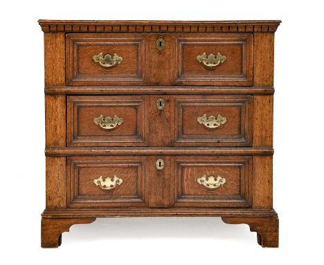 A Late 17th Century Oak Chest, the moulded top above a dentil moulding with three deep two-as-one geometric moulded drawers b